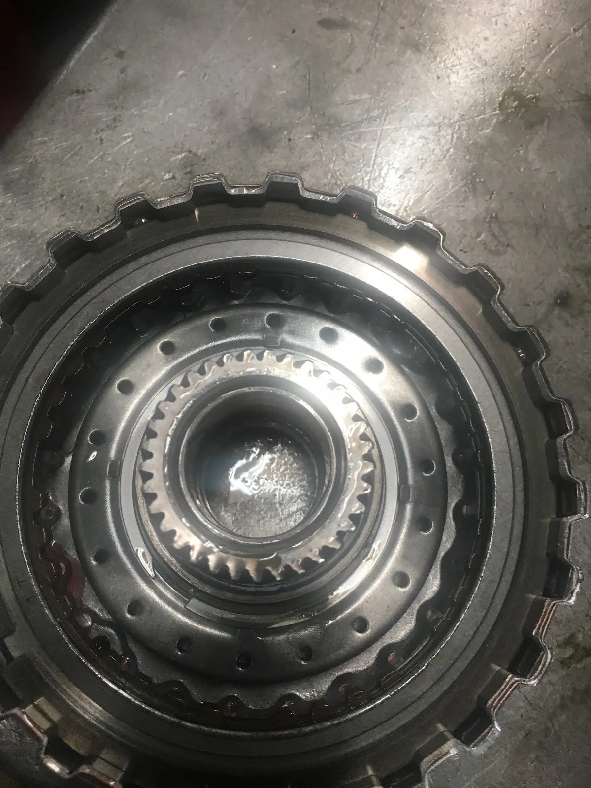 Close-up of a transmission clutch drum and splines during a rebuild.
