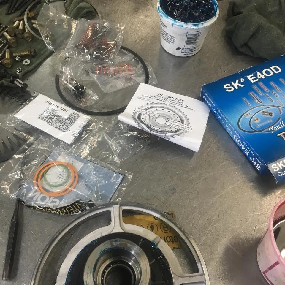 A new master rebuild kit for a Ford E4OD transmission, with seals, gaskets and a drum on the bench.