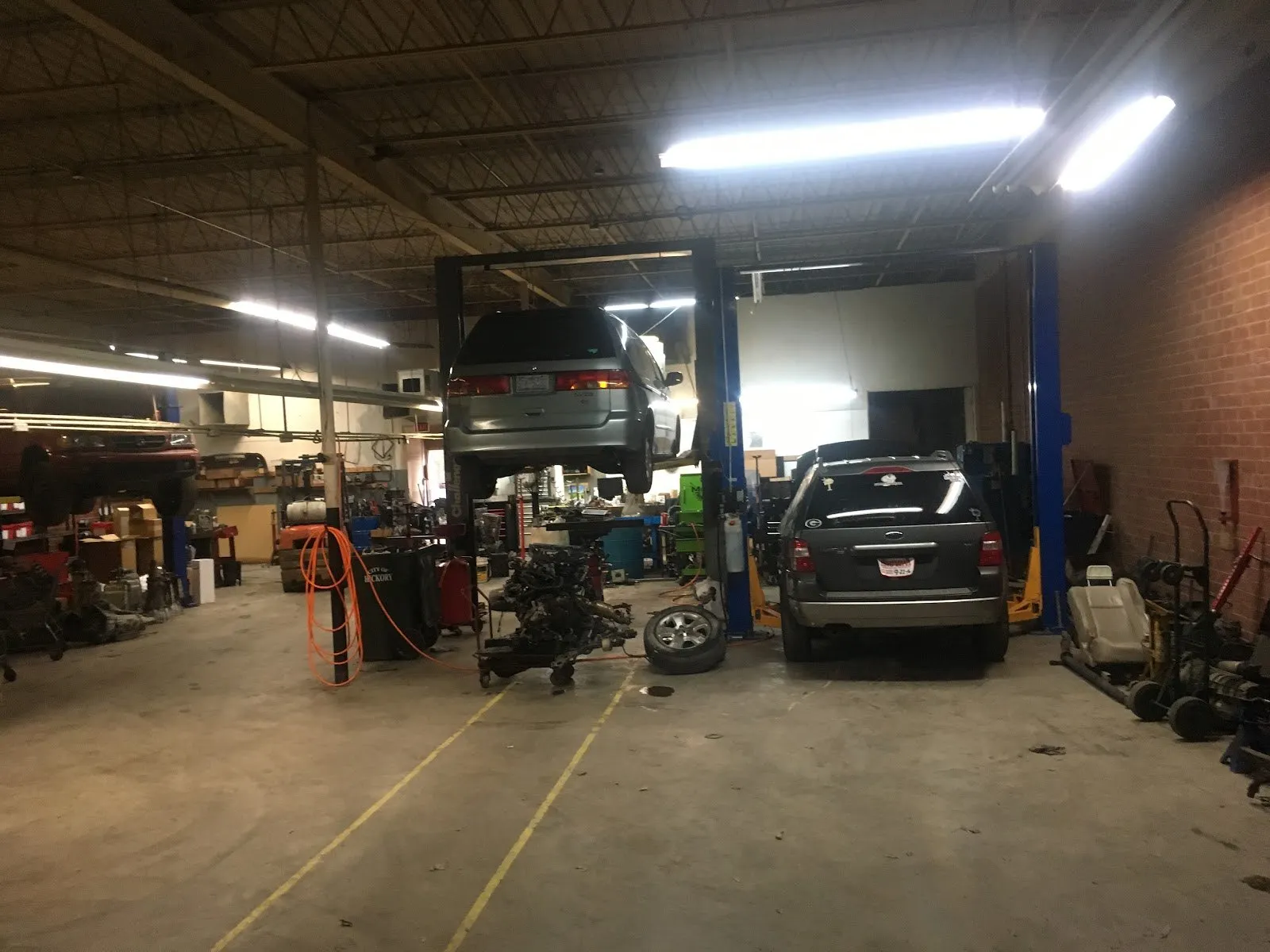 Two-post lifts and vehicles in the Transpecialists service bays.